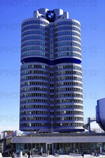 Four cylindrical towers of the BMW building under a bright blue sky, BMW WELT, Munich, Germany, Europe