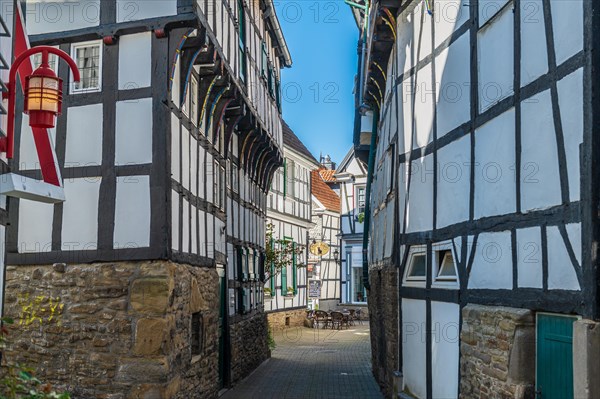 A narrow alley with traditional German half-timbered houses and cobblestones, Old Town, Hattingen, Ennepe-Ruhr district, Ruhr area, North Rhine-Westphalia