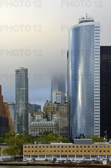 High-rise building 17 State Street at Battery Park, One World Trade Centre or Freedom Tower in the clouds, Financial District, Lower Manhattan, New York City, New York, USA, North America