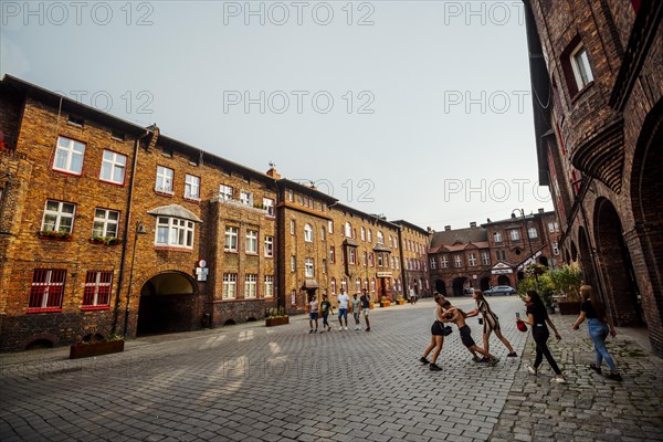 Nikiszowiec, Poland, 14 April, 2020: Group of kids fighting on the courtyard in Katowice mining district, Silesia, Europe