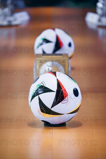 Two footballs lie on the cabinet table during a cabinet meeting at the Federal Chancellery in Berlin, 06/03/2024