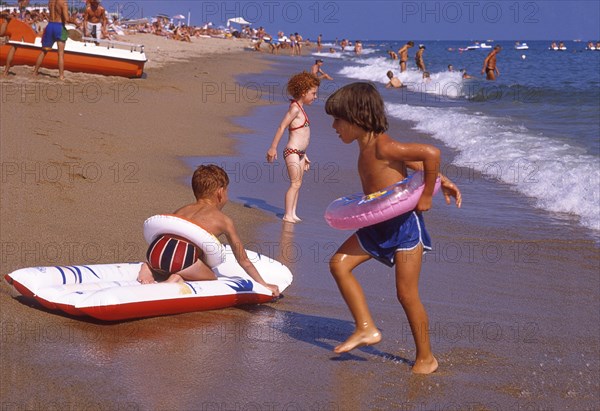 Children playing on the beach in Calella, Costa Brava, Barselona, Catalonia, Spain, Southern Europe. Scanned 6x6 slide, Europe