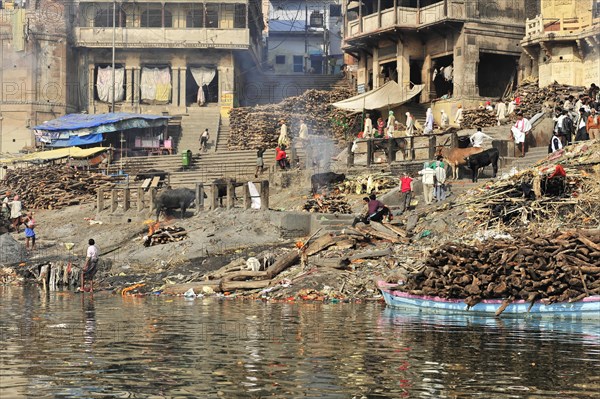 Varanasi Ghats with logs for cremation rituals along the river, Varanasi, Uttar Pradesh, India, Asia