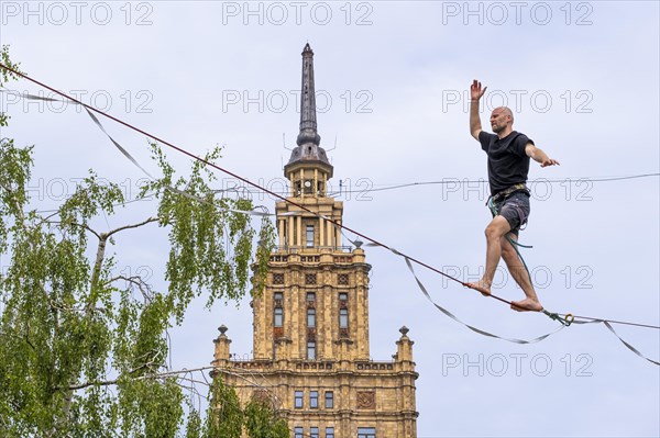 Riga. Alternative cultural centre near the Latvian Academy of Science. Tightrope walker on the slackline, Riga, Latvia, Europe