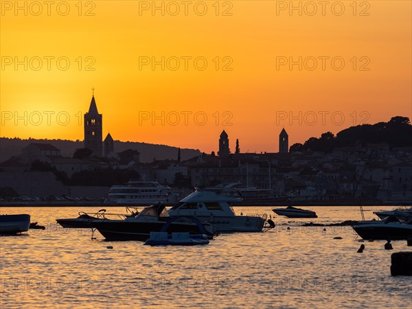 Boats anchoring in a bay, silhouette of church towers, evening mood after sunset over Rab, town of Rab, island of Rab, Kvarner Gulf Bay, Croatia, Europe