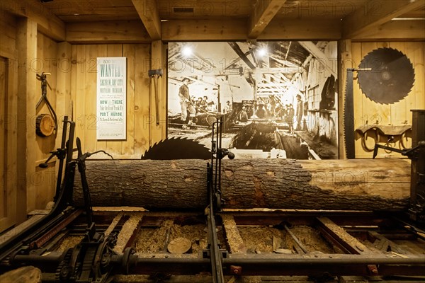 Lansing, Michigan, The Michigan History Museum. A log is cut in a sawmill display. Most of Michigan's forests were cut down between 1840 and 1900