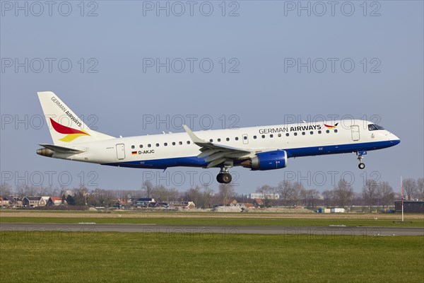 German Airways Embraer E190SR with registration D-AKJC lands on the Polderbaan, Amsterdam Schiphol Airport in Vijfhuizen, municipality of Haarlemmermeer, Noord-Holland, Netherlands