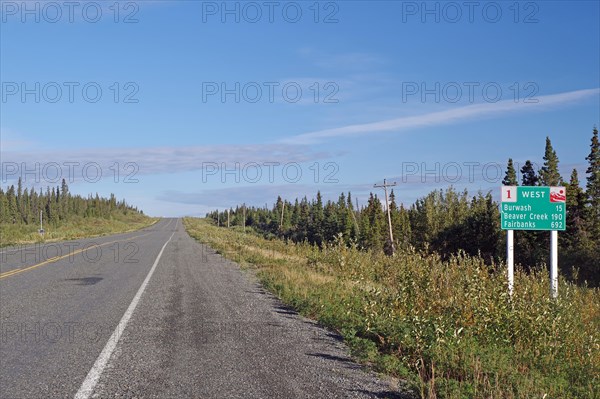 Road leads as endless grades through wilderness, no traffic and one traffic sign, Alaska Highway, Yukon Territory, Canada, North America