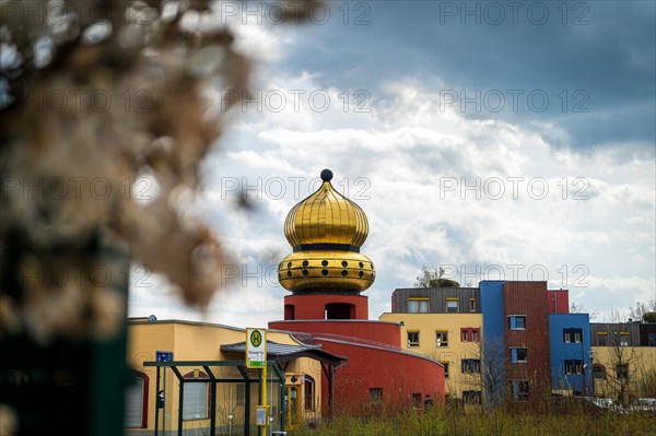 A building with a golden dome, blurred nature in the foreground, urban environment, Hundertwasser Kindergarten, Wuelfrath, Mettmann, North Rhine-Westphalia
