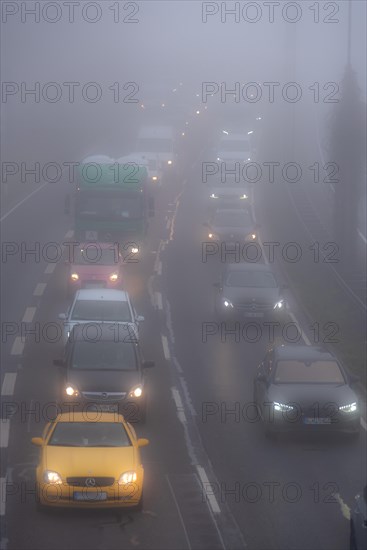 Cars driving on a foggy road with poor visibility in the grey daylight, Magdeburg, Saxony-Anhalt, Germany, Europe