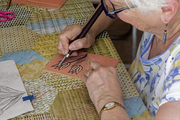 Oaxaca, Mexico, Susan Newell works on her image of tulips at an engraving workshop led by Alejandra Canseco Alhil at her art studio, Central America