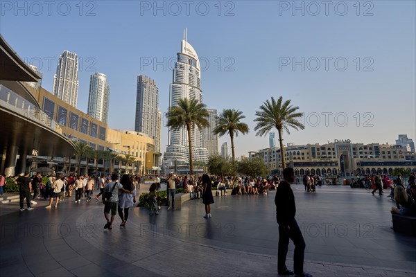 Tourists in front of the skyscraper backdrop at Lake Burj Khalifa. Dubai, United Arab Emirates, Asia