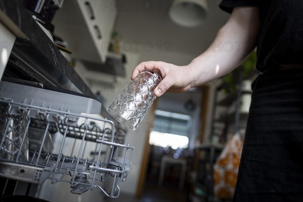 A man loads a dishwasher. Berlin, 08.03.2024