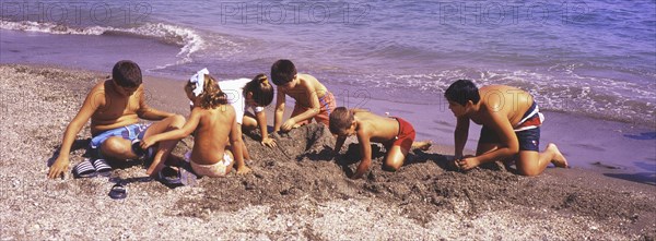 Children playing on the beach in Torre del Mar, Costa del Sol, Malaga province, Andalusia, Spain, Southern Europe. Scanned slide, Europe