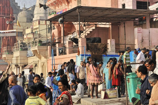 Group of people waiting in a queue on the street next to city buildings, Varanasi, Uttar Pradesh, India, Asia