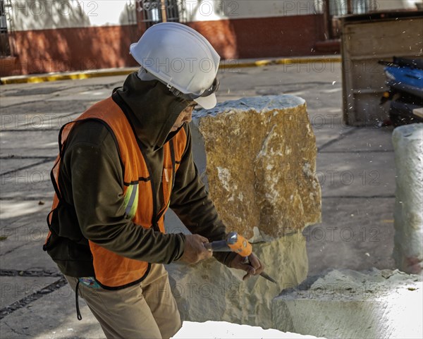Oaxaca, Mexico, A worker chisels a block of stone to use in repairs on Guadalupe Church, Central America
