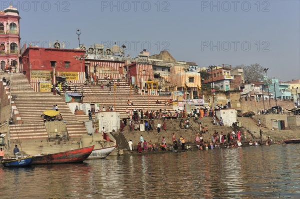 Lively riverside promenade with crowds and traditional buildings, Varanasi, Uttar Pradesh, India, Asia