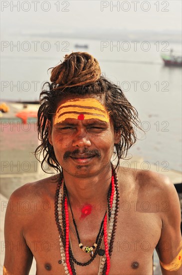Portrait of a sadhu with face painting and religious symbols in Varanasi, Varanasi, Uttar Pradesh, India, Asia