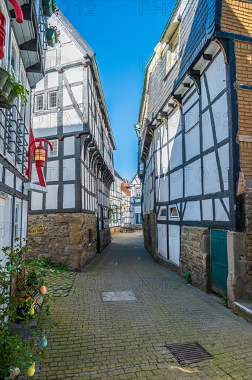 Sun-drenched alleyway with shadow effect between German half-timbered houses, Old Town, Hattingen, Ennepe-Ruhr district, Ruhr area, North Rhine-Westphalia