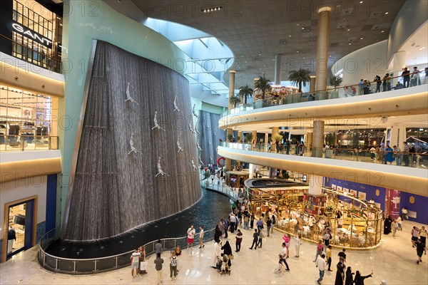 Artificial waterfall in the Dubai Mall shopping centre. The largest mall in the world offers countless shopping and entertainment options. Dubai, United Arab Emirates, Asia