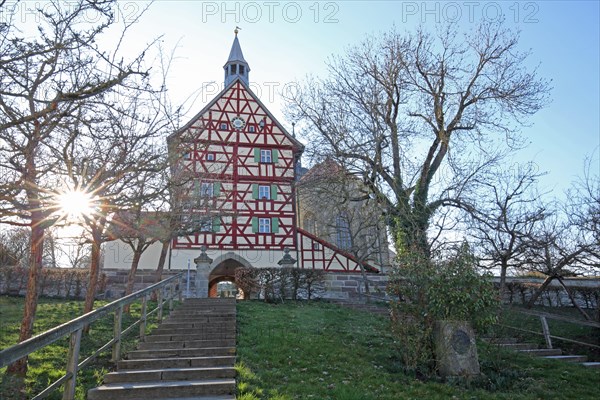 Historic gate tower built in 1545 in backlight and landmark, gatehouse, half-timbered house, Burgbernheim, Middle Franconia, Franconia, Bavaria, Germany, Europe