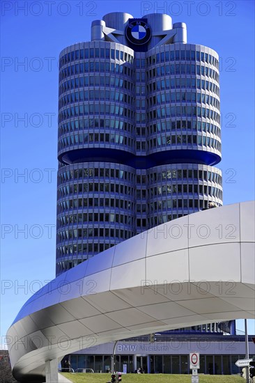 Striking tower with blue BMW symbol and futuristic architecture under a blue sky, BMW WELT, Munich, Germany, Europe