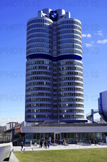 The BMW building with its striking shape and people in front of it on a sunny day, BMW WELT, Munich, Germany, Europe