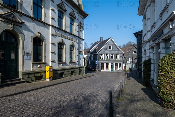 A deserted street surrounded by traditional half-timbered architecture on a clear day, Graefrath, Solingen, Bergisches Land, North Rhine-Westphalia