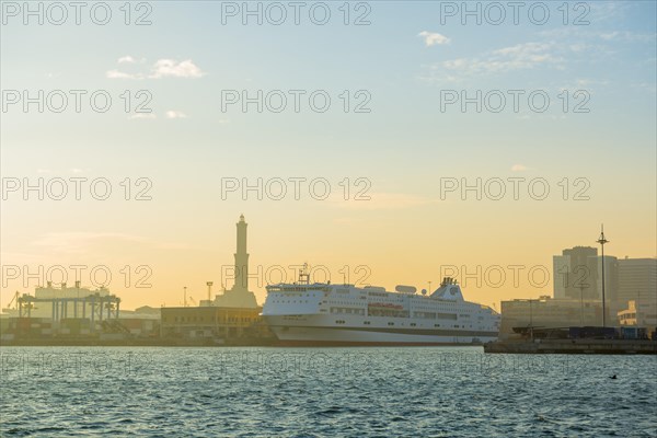 Port with Passenger Ship and Lighthouse in Sunset in Genoa, Italy, Europe