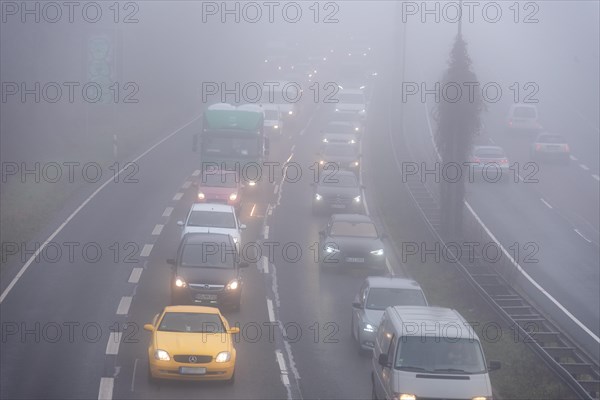 Cars driving on a foggy road with poor visibility in the grey daylight, Magdeburg, Saxony-Anhalt, Germany, Europe