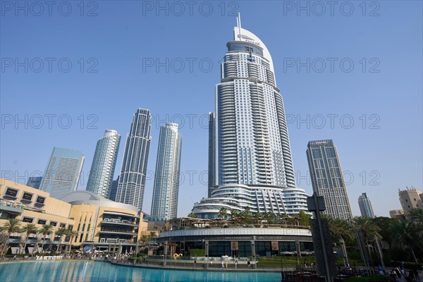 Tourists in front of the skyscraper backdrop at Lake Burj Khalifa. Dubai, United Arab Emirates, Asia