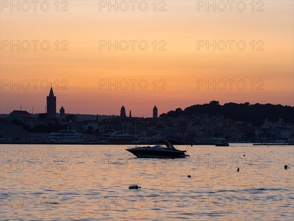 Boats anchoring in a bay, church towers, evening mood after sunset over Rab, town of Rab, island of Rab, Kvarner Gulf Bay, Croatia, Europe