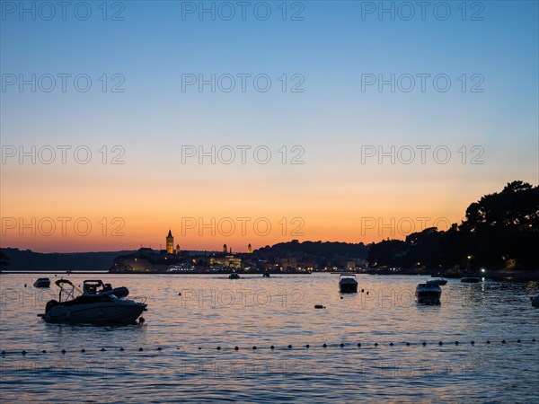 Boats anchoring in a bay, church towers, sunset over Rab, town of Rab, island of Rab, Kvarner Gulf Bay, Croatia, Europe