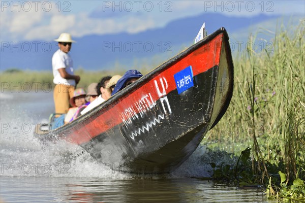 Fast boat with passengers travelling on a river, Inle Lake, Myanmar, Asia