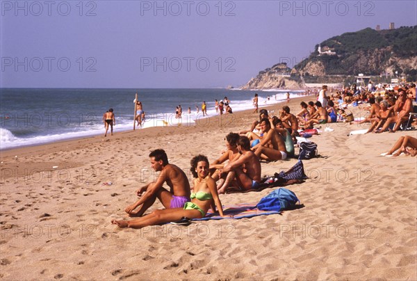 Sunbathers on the beach in Calella, Costa Brava, Barselona, Catalonia, Spain, Southern Europe. Scanned 6x6 slide, Europe