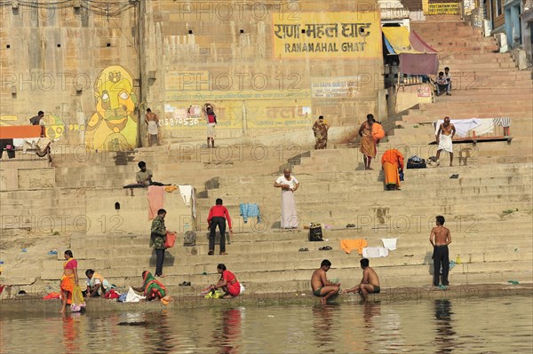 People performing ritual ablutions and prayers at the traditional ghats by the river, Varanasi, Uttar Pradesh, India, Asia