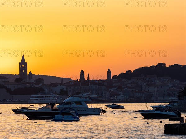 Boats anchoring in a bay, silhouette of church towers, evening mood after sunset over Rab, town of Rab, island of Rab, Kvarner Gulf Bay, Croatia, Europe