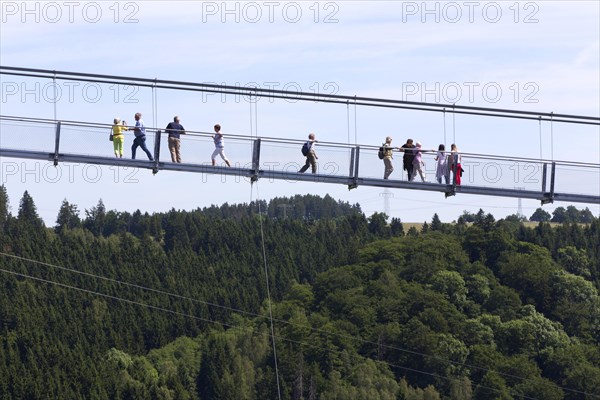 Visitors cross the rope suspension bridge at the Rappbode dam, 483 metres long, 100 metres above the valley floor, Oberharz, 11.06.2017