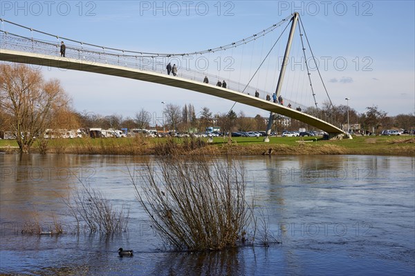 The curved suspension bridge designed by Joerg Schlaich, called Glacisbruecke, crosses the Weser near Minden, Muehlenkreis Minden-Luebbecke, North Rhine-Westphalia, Germany, Europe
