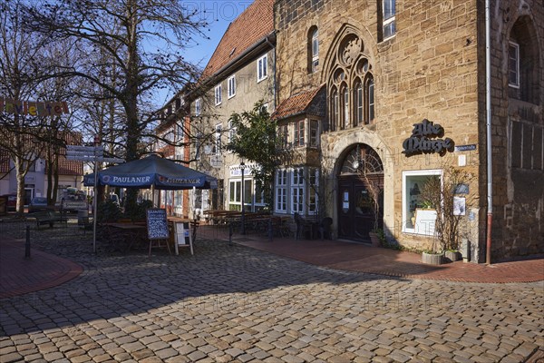 Alte Muenze restaurant with outdoor area, umbrella and benches in the Schnurrviertel in Minden, Muehlenkreis Minden-Luebbecke, North Rhine-Westphalia, Germany, Europe