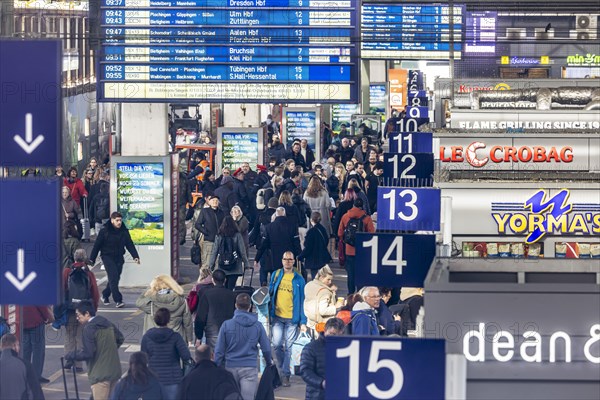 Central station, travellers in the platform hall. Extensive construction work on the railway network is communicated on the display board, Stuttgart, Baden-Wuerttemberg, Germany, Europe