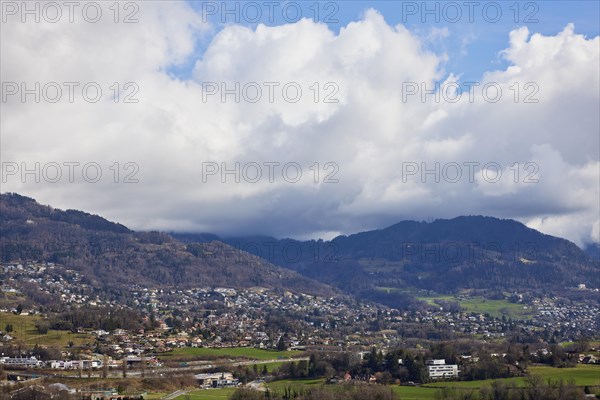 Mighty white spring clouds move over mountains near Jongny, Jongny, Riviera-Pays-d'Enhaut district, Vaud, Switzerland, Europe