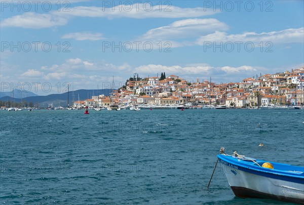 View of a picturesque Mediterranean town with boats and a lively waterfront promenade, Poros, Poros Island, Saronic Islands, Peloponnese, Greece, Europe