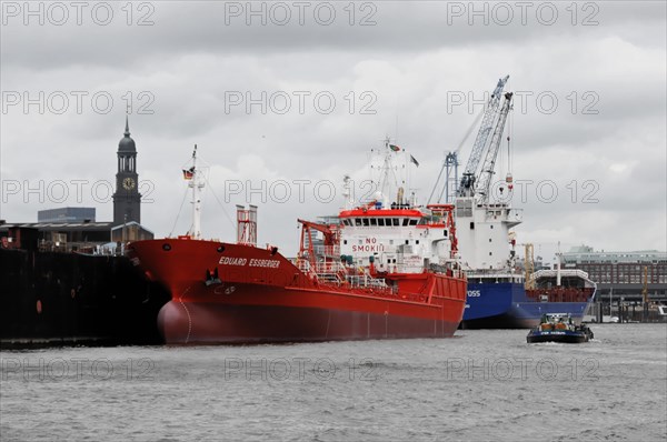 Red tanker in harbour water under cloudy sky, surrounded by harbour facilities, Hamburg, Hanseatic City of Hamburg, Germany, Europe