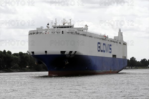 A large cargo ship named GLOVIS on a river under a cloudy sky, Hamburg, Hanseatic City of Hamburg, Germany, Europe