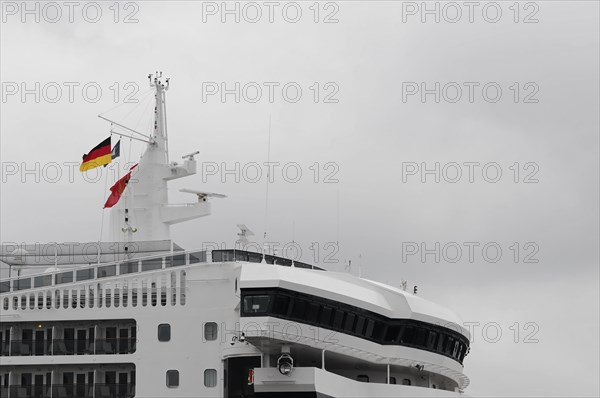 German flag flying on the bridge of a white cruise ship, Queen Mary 2, Hamburg, Hanseatic City of Hamburg, Germany, Europe
