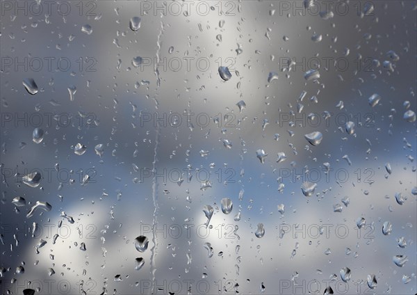 Raindrops on a window pane, North Rhine-Westphalia, Germany, Europe