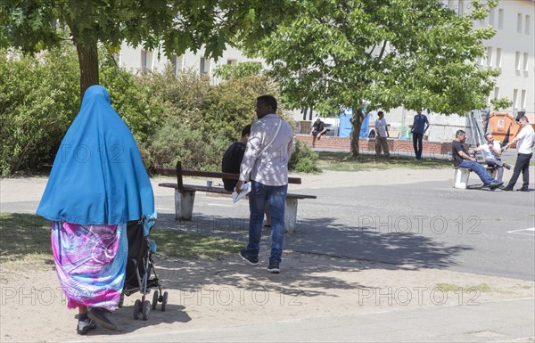 Refugees at the central contact point for asylum seekers in Brandenburg, Eisenhuettenstadt, 3 June 2015