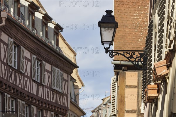 Lantern on a house and facade of a half-timbered house in the old town centre of Colmar, Department Haut-Rhin, Grand Est, France, Europe