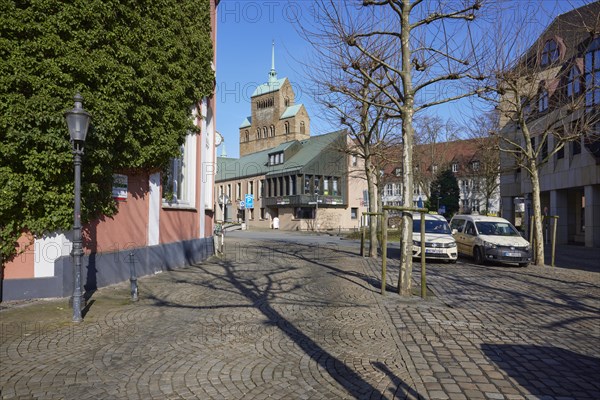 City centre with cobblestones, lantern, taxis at the taxi rank and commercial buildings and the cathedral of Minden, Muehlenkreis Minden-Luebbecke, North Rhine-Westphalia, Germany, Europe